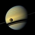 Titan in front of Saturn, Credit: NASA/JPL-Caltech/SSI